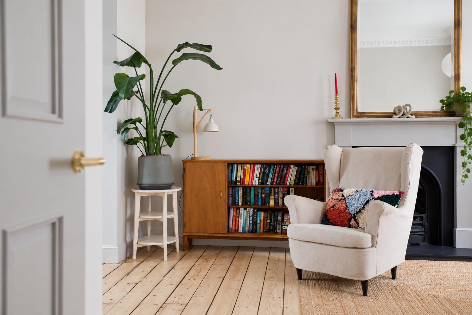 Cozy reading nook with fireplace charm, books, and bright natural style