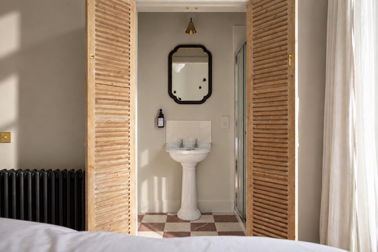 Charming ensuite nook with vintage sink and warm natural light