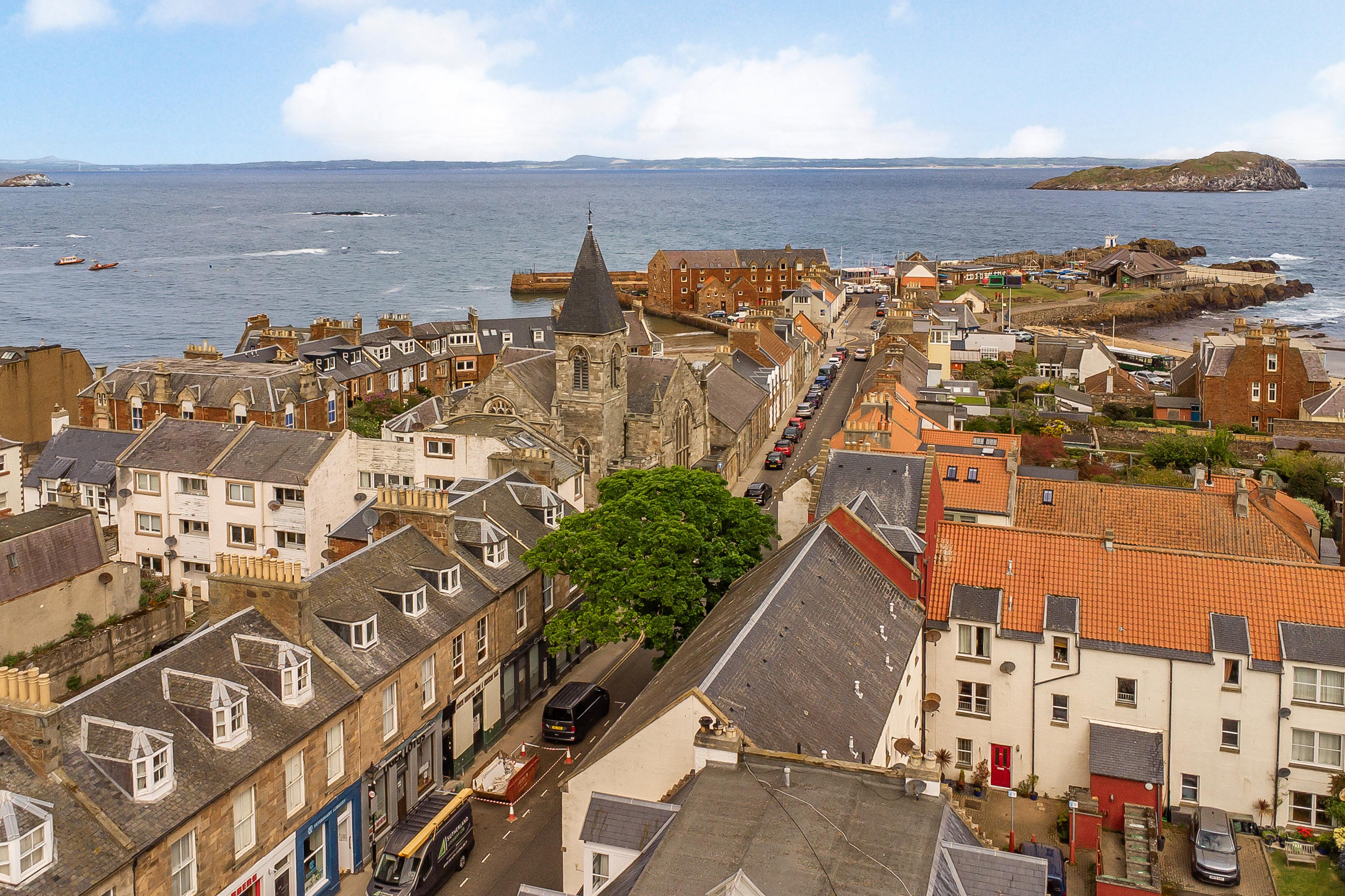 Elevated coastal town views with harbor, sea, and historic charm